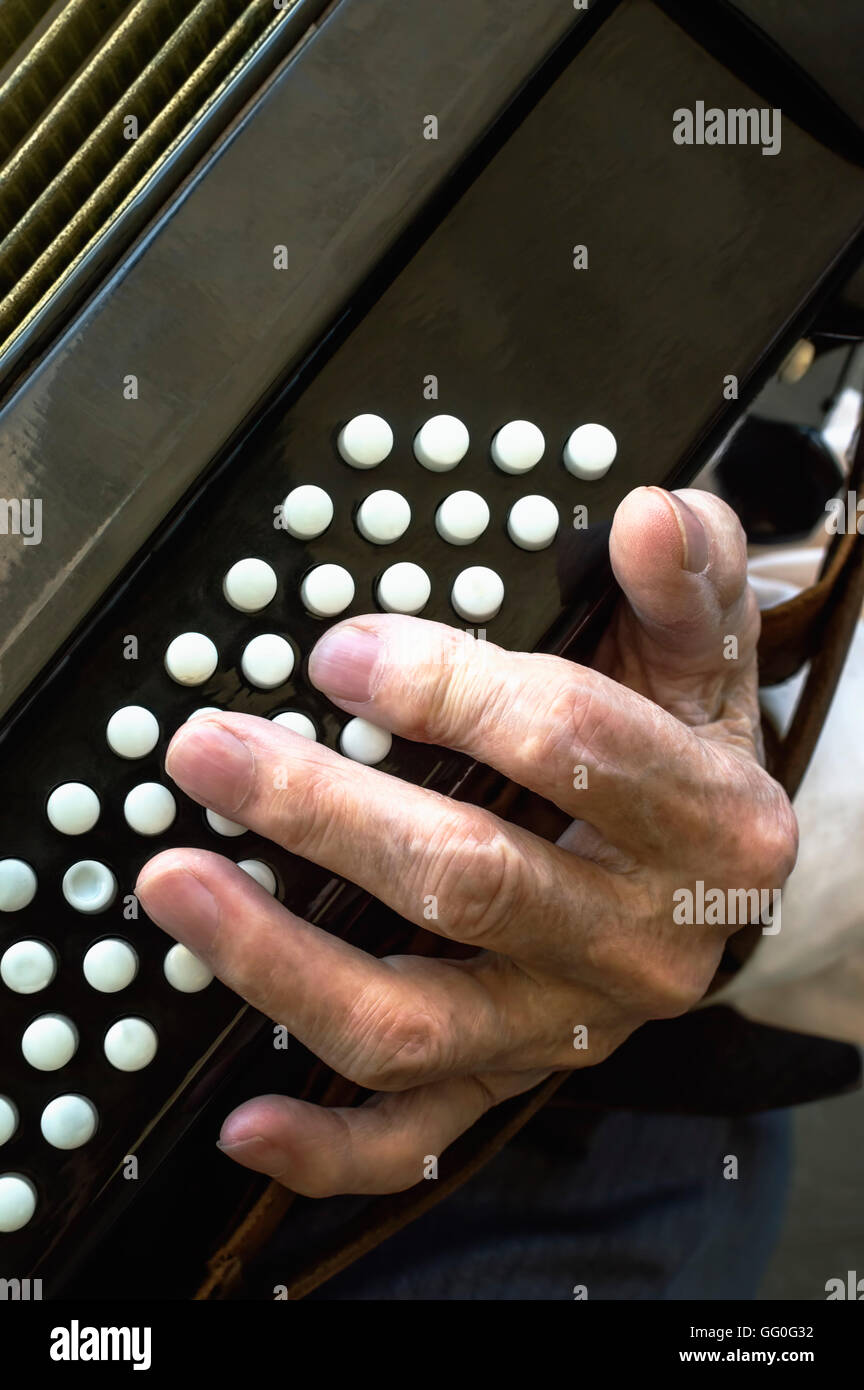 Details of a hand on an old accordion while playing. Selective focus. Stock Photo