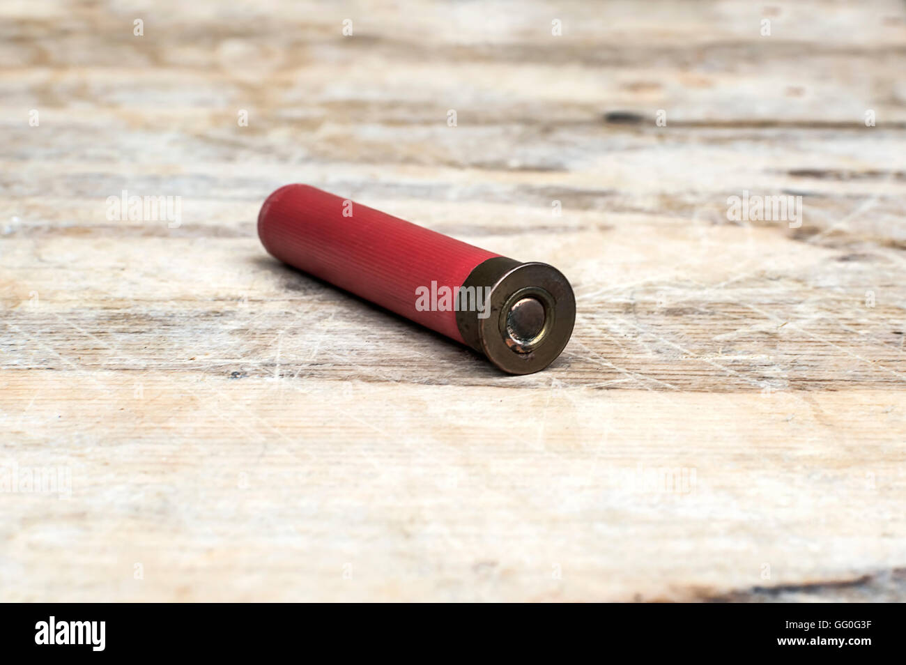 Close up of 12mm bullet on wooden table. Selective focus. Stock Photo