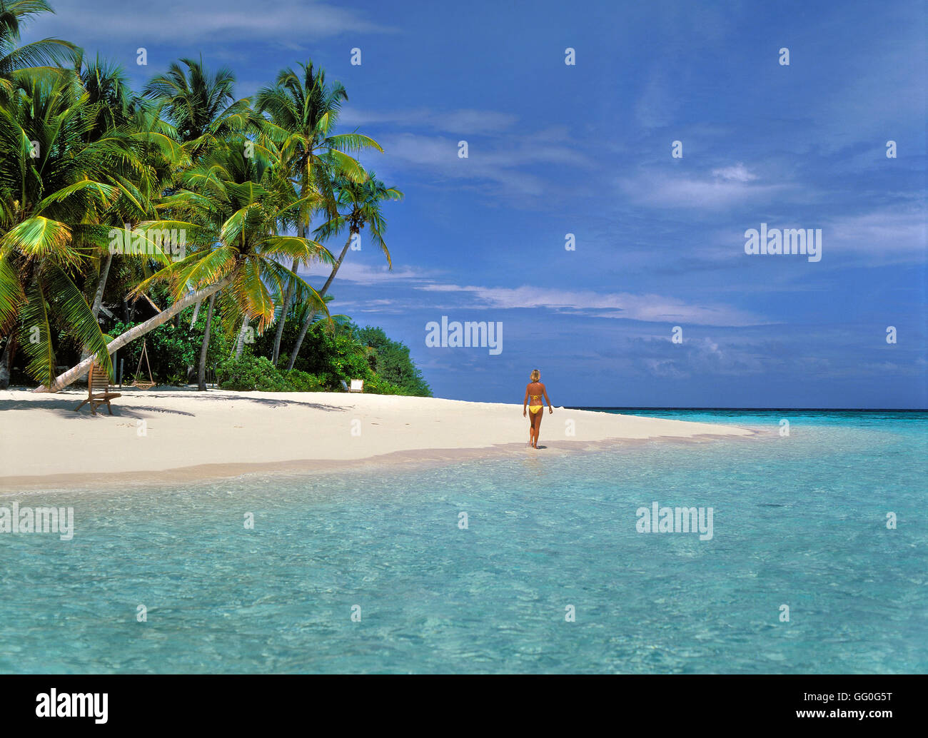 Girl in yellow bikini on Maldives Beach, Angsana Ihuru Island, North