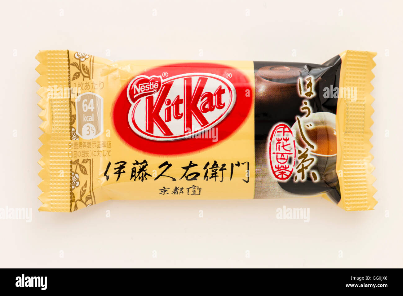 Japanese kitkat. Single wrapped chocolate bar, coffee favour, cream coloured wrapper. Plain background. Stock Photo