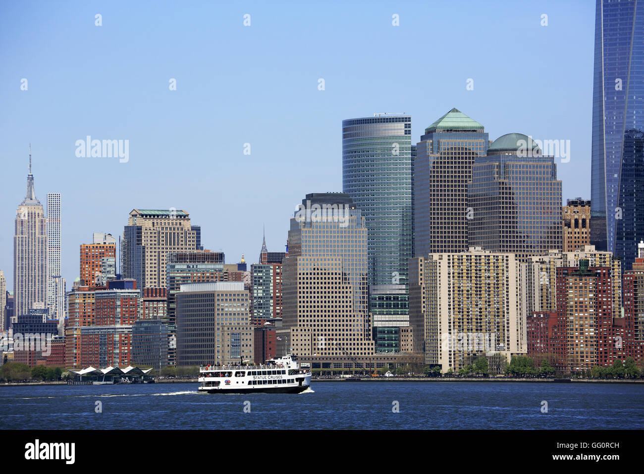 Skyline of Lower and Midtown Manhattan with a ferryboat in the waterfront,Upper New York Bay,New York harbor,New York City,USA Stock Photo