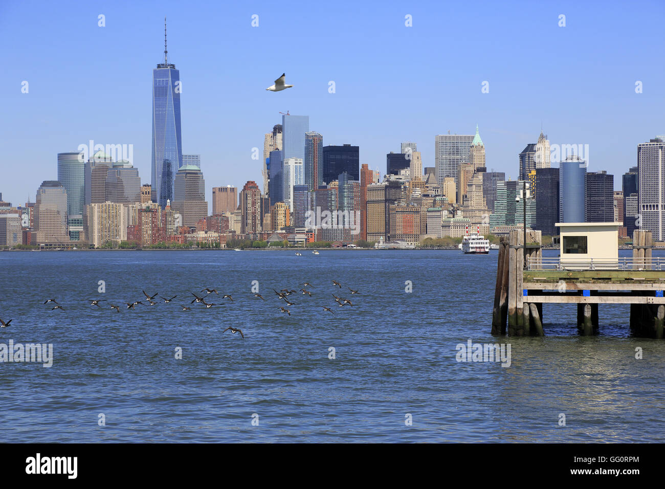 View of Lower Manhattan with Freedom Tower with a old pier of Liberty ...