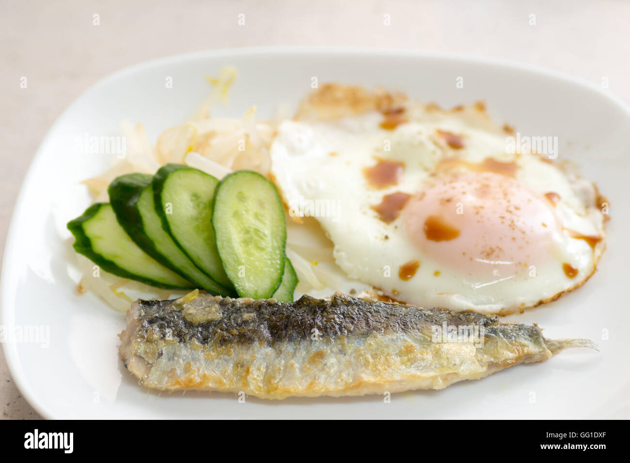 Japanese cuisine a dish of fried sardine with salada and egg Stock