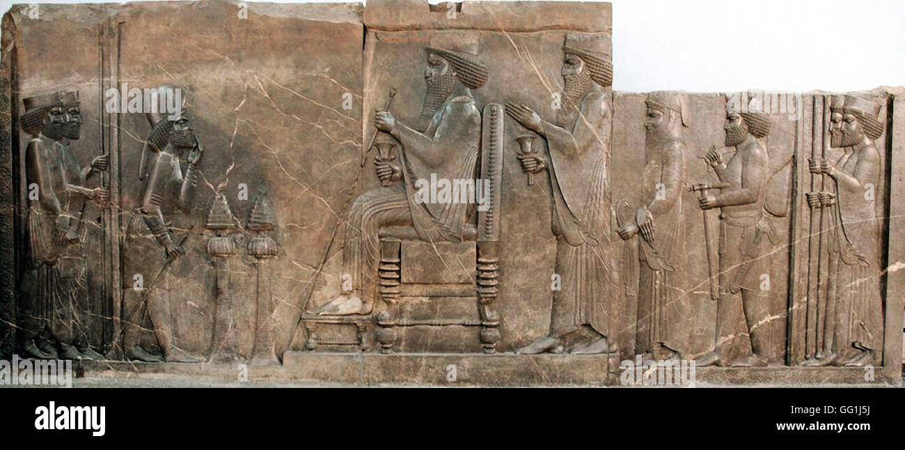 227. LIMESTONE RELIEF OF KING DARIUS SEATED ON THRONE, CROWN PRINCE XERXES, GUARDS AND ATENDANTS  BEHIND HIM.  PERSEPOLIS, CA. 5 Stock Photo