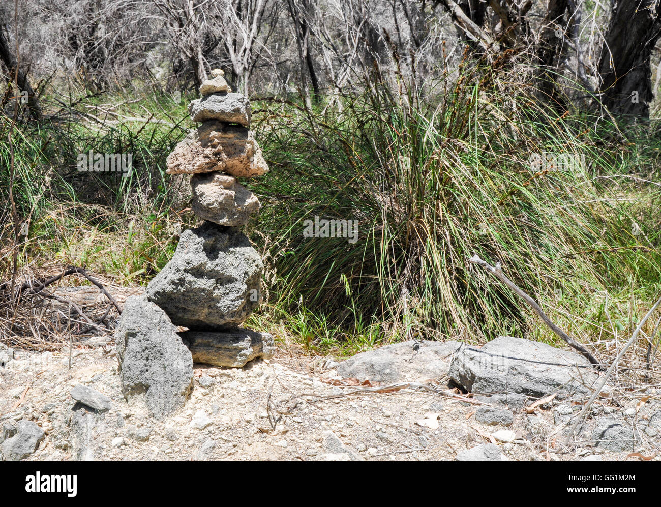 Conical pile of rocks, cairns, in a wetland nature setting at Lake