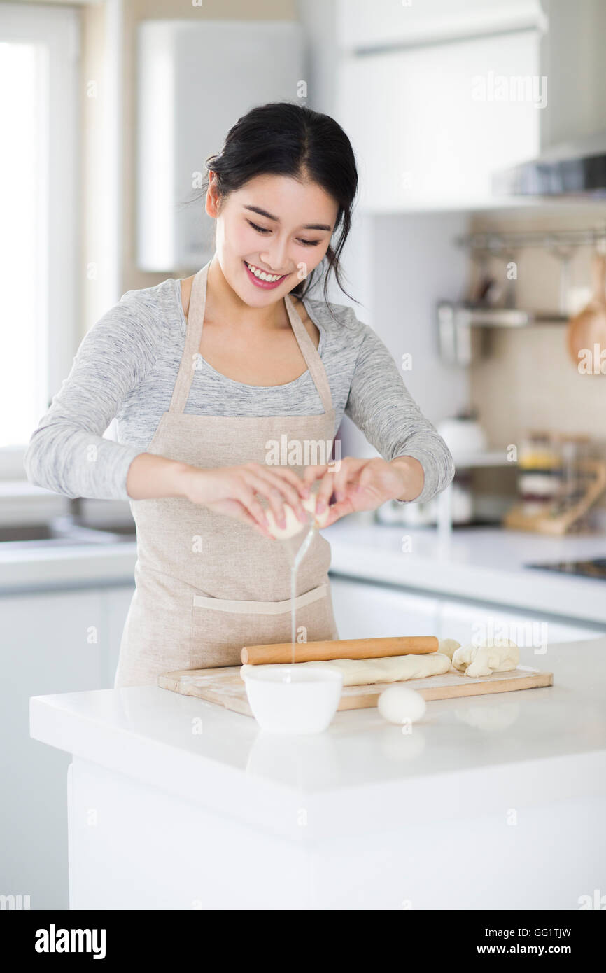 Cheerful Young Chinese Woman Cooking In Kitchen Stock Photo Alamy cheerful-young-chinese-woman-cooking-in-kitchen-stock-photo-alamy