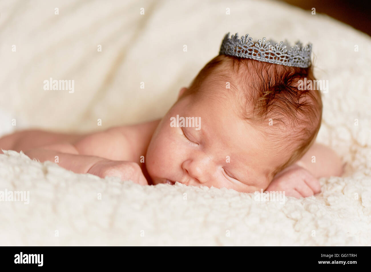 The baby, newly born, lies on the bright plaid and sleeping, handle the ...
