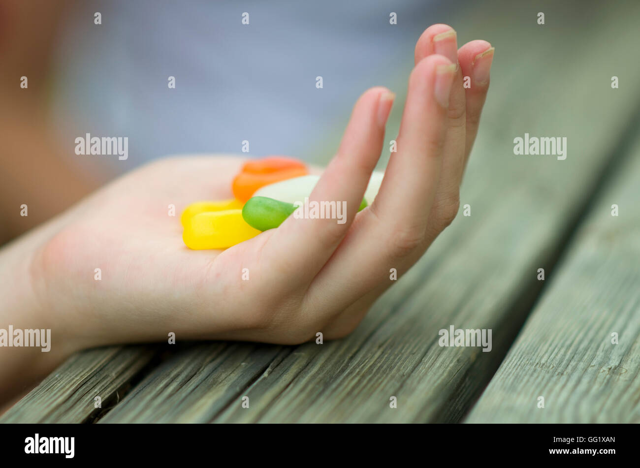 Colourful jelly beans in a cupped hand. Stock Photo