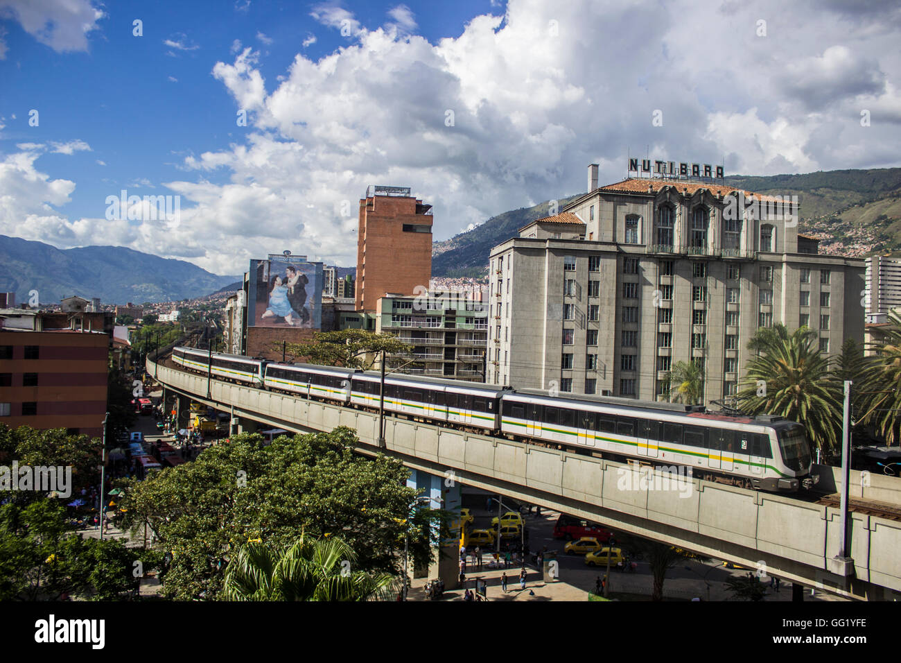 A metro train runs through downtown Medellin, Colombia Stock Photo
