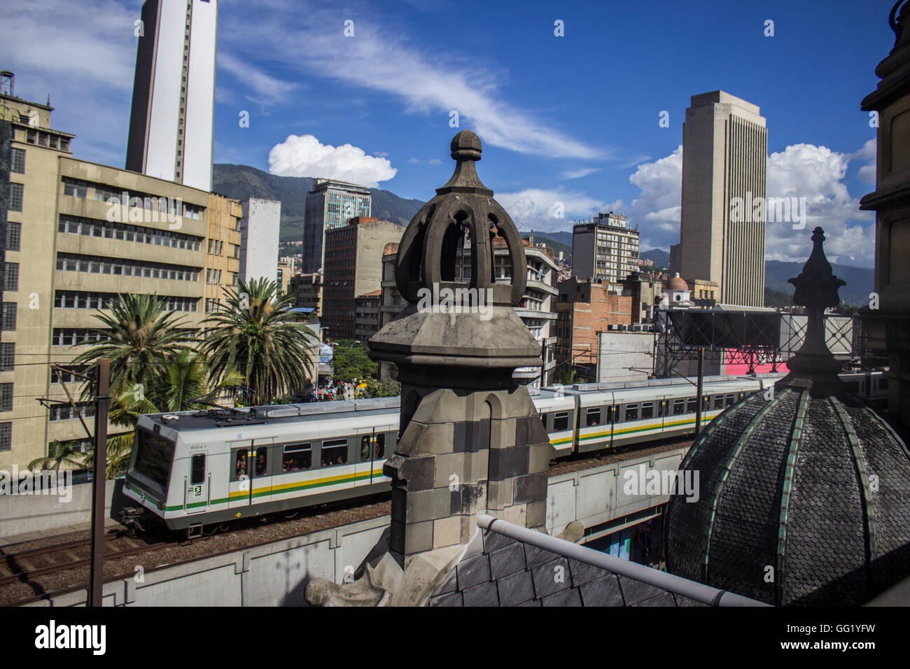 A metro train runs through downtown Medellin Stock Photo