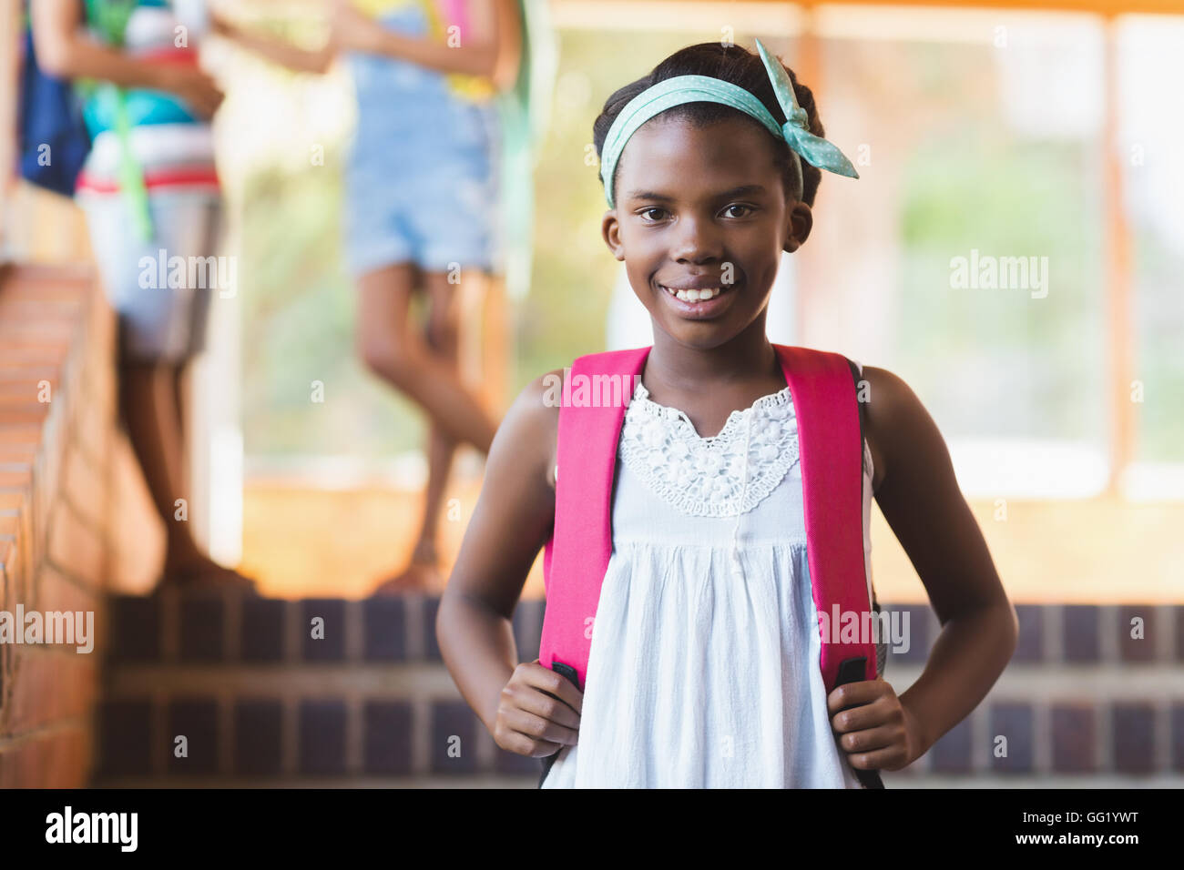 Portrait of school girl standing in school corridor Stock Photo - Alamy