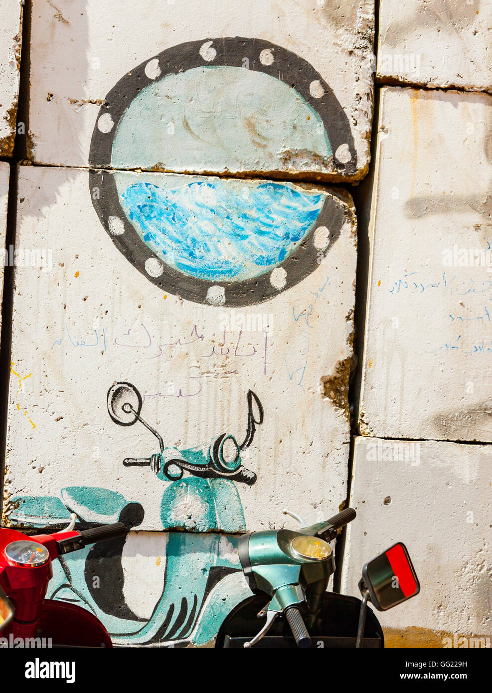 Egypt, Cairo, Street Art.There's a real blue scooter in front of the wall, confusing with another one painted on the wall. Stock Photo