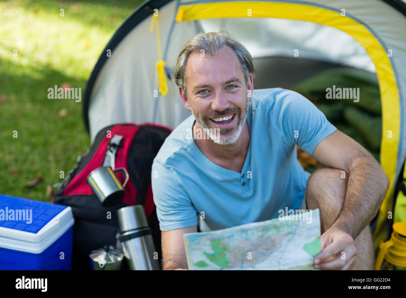 Portrait of happy hiker holding map Stock Photo - Alamy