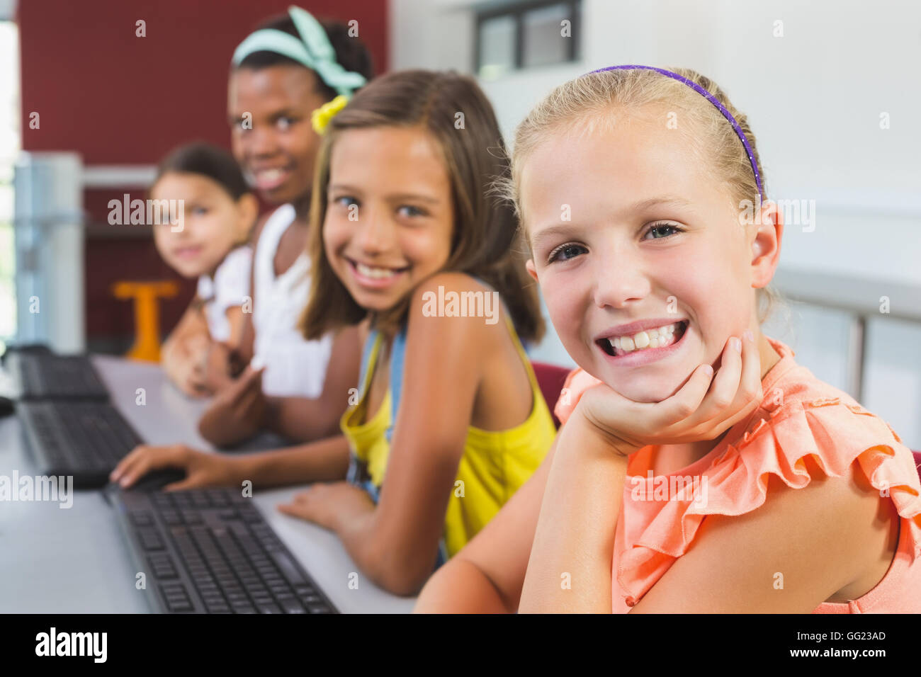 Happy schoolgirls smiling in classroom Stock Photo - Alamy