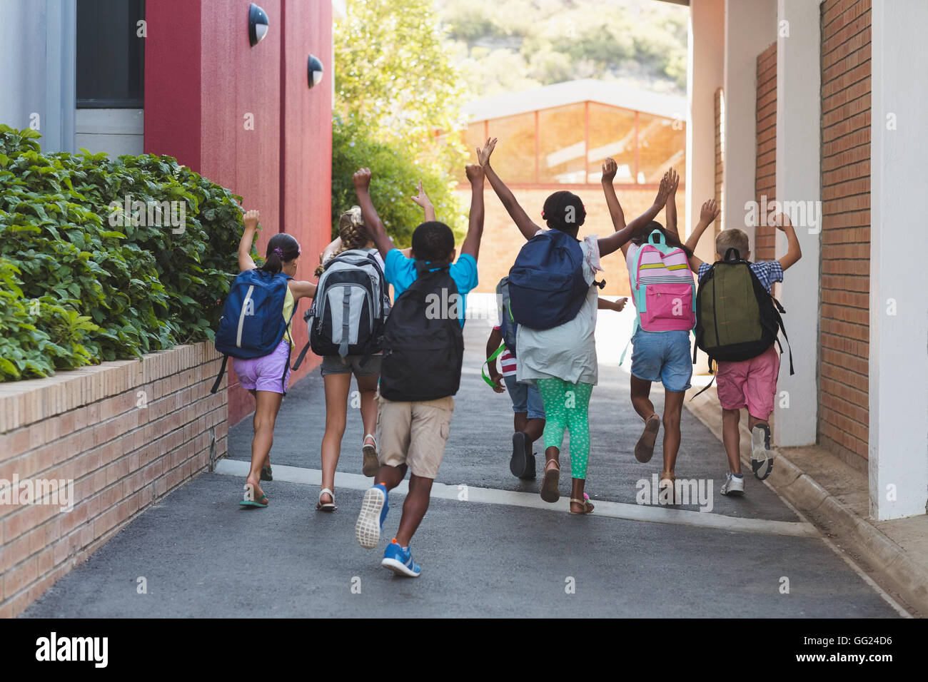 Rear view of classmates running at school campus Stock Photo - Alamy