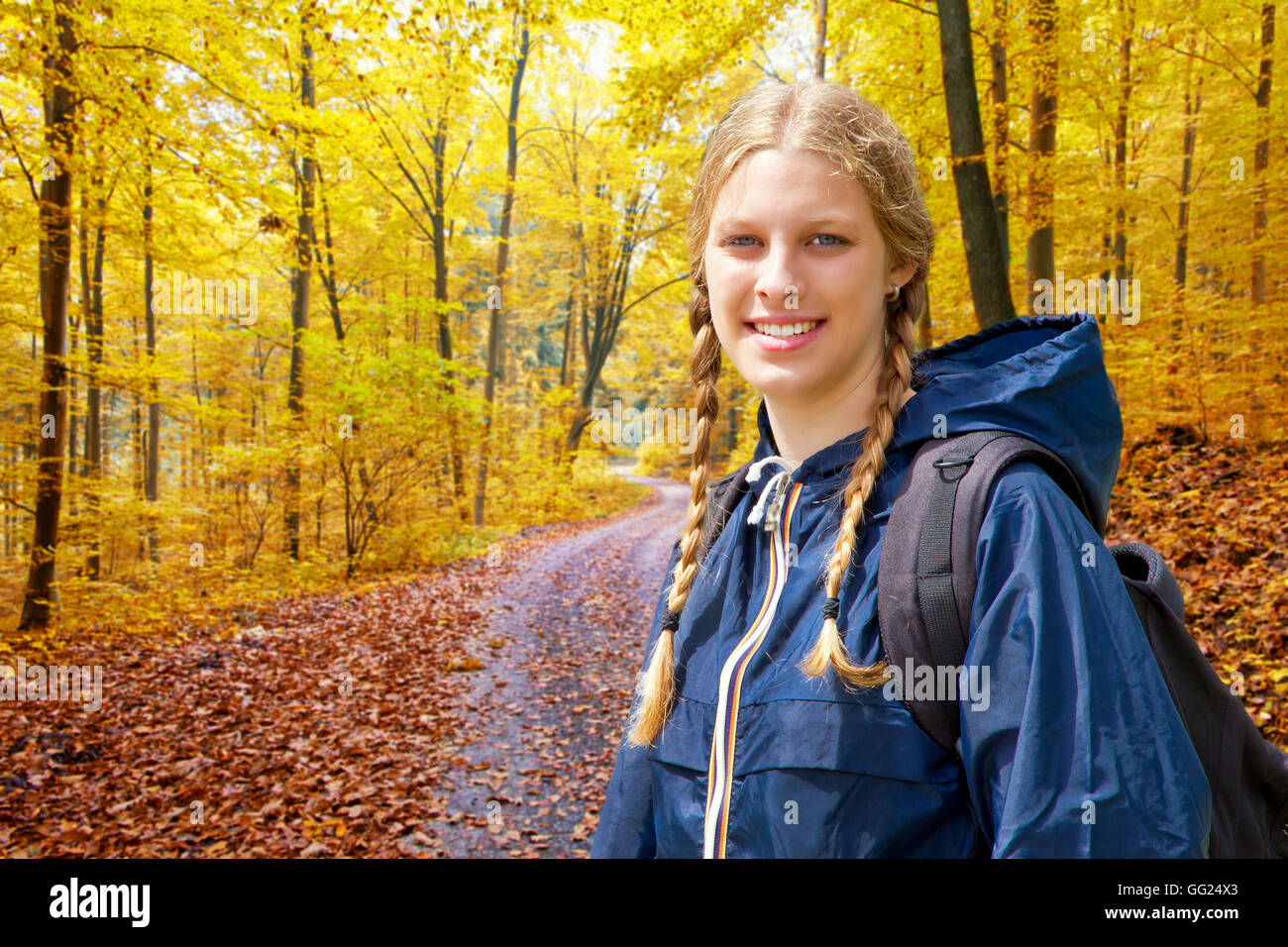 Young woman hiking in a autumn forest Stock Photo - Alamy