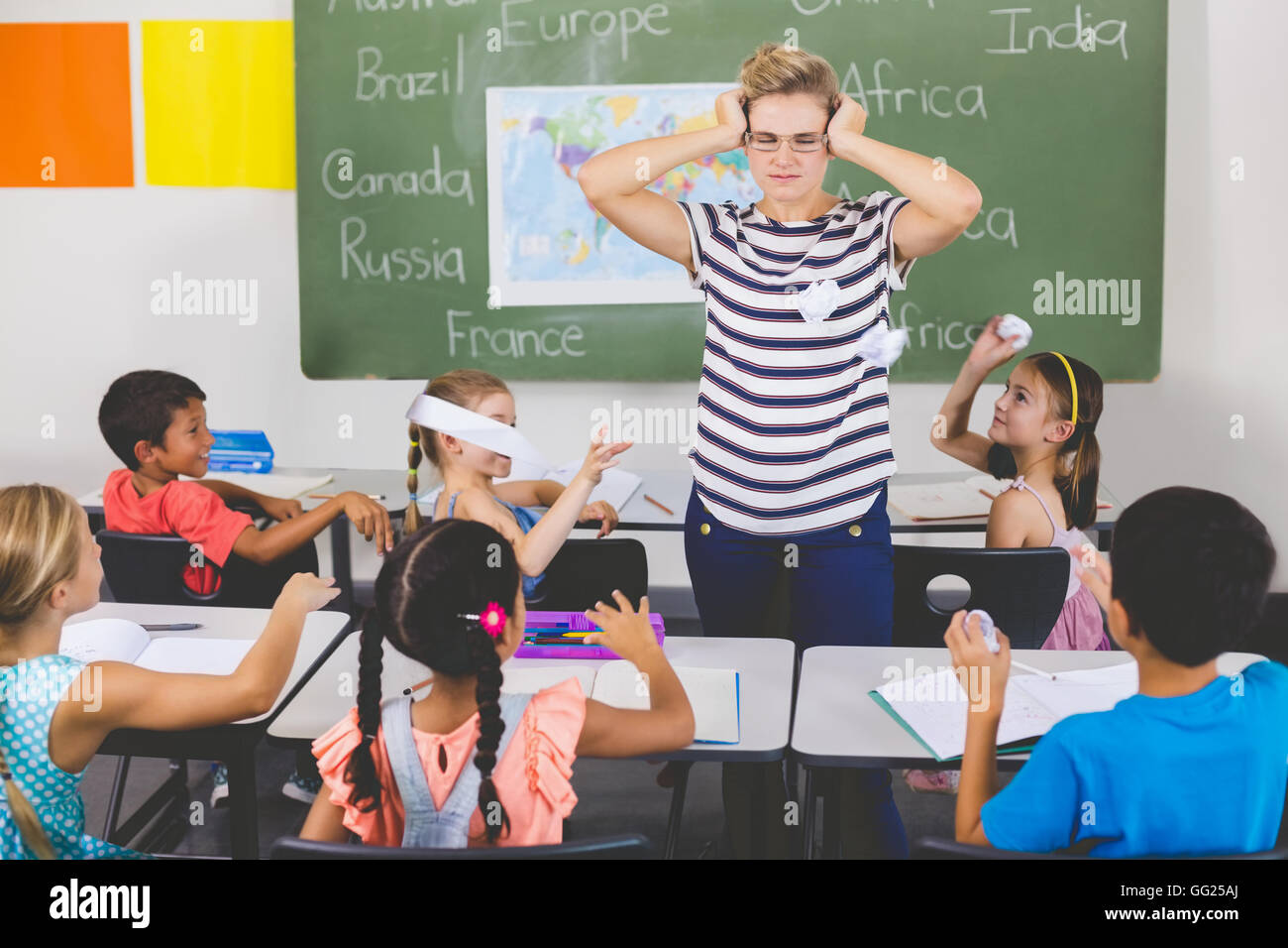 School kids throwing paper balls on teacher Stock Photo Alamy