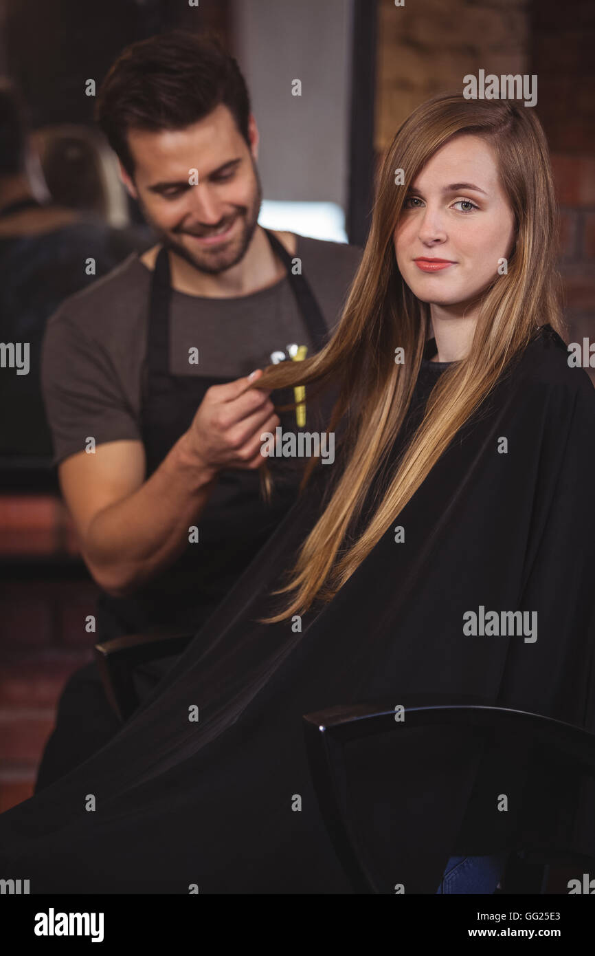 Handsome hair stylist with client Stock Photo - Alamy