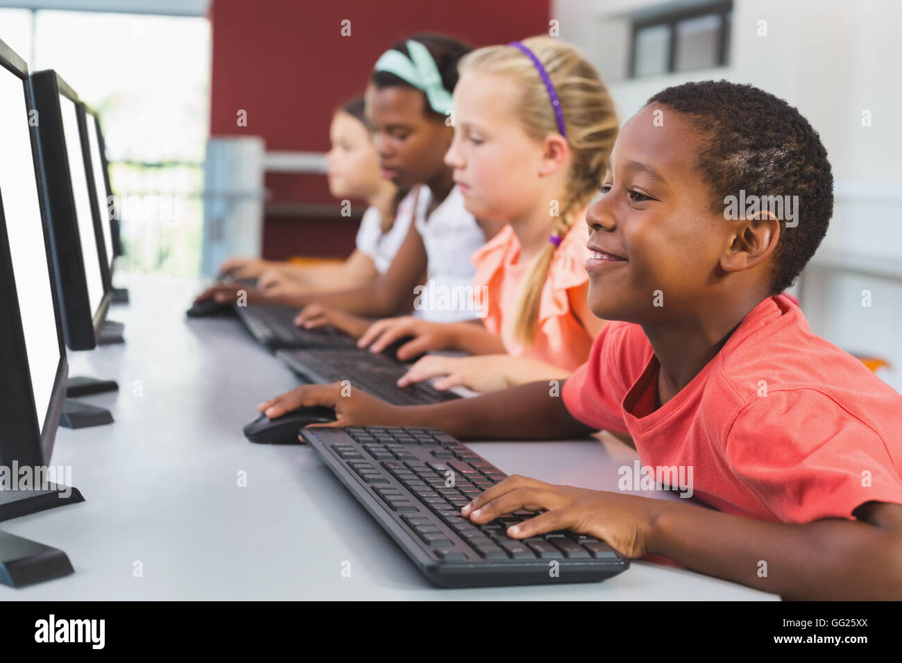 School Kids Using Computer In Classroom Stock Photo Alamy