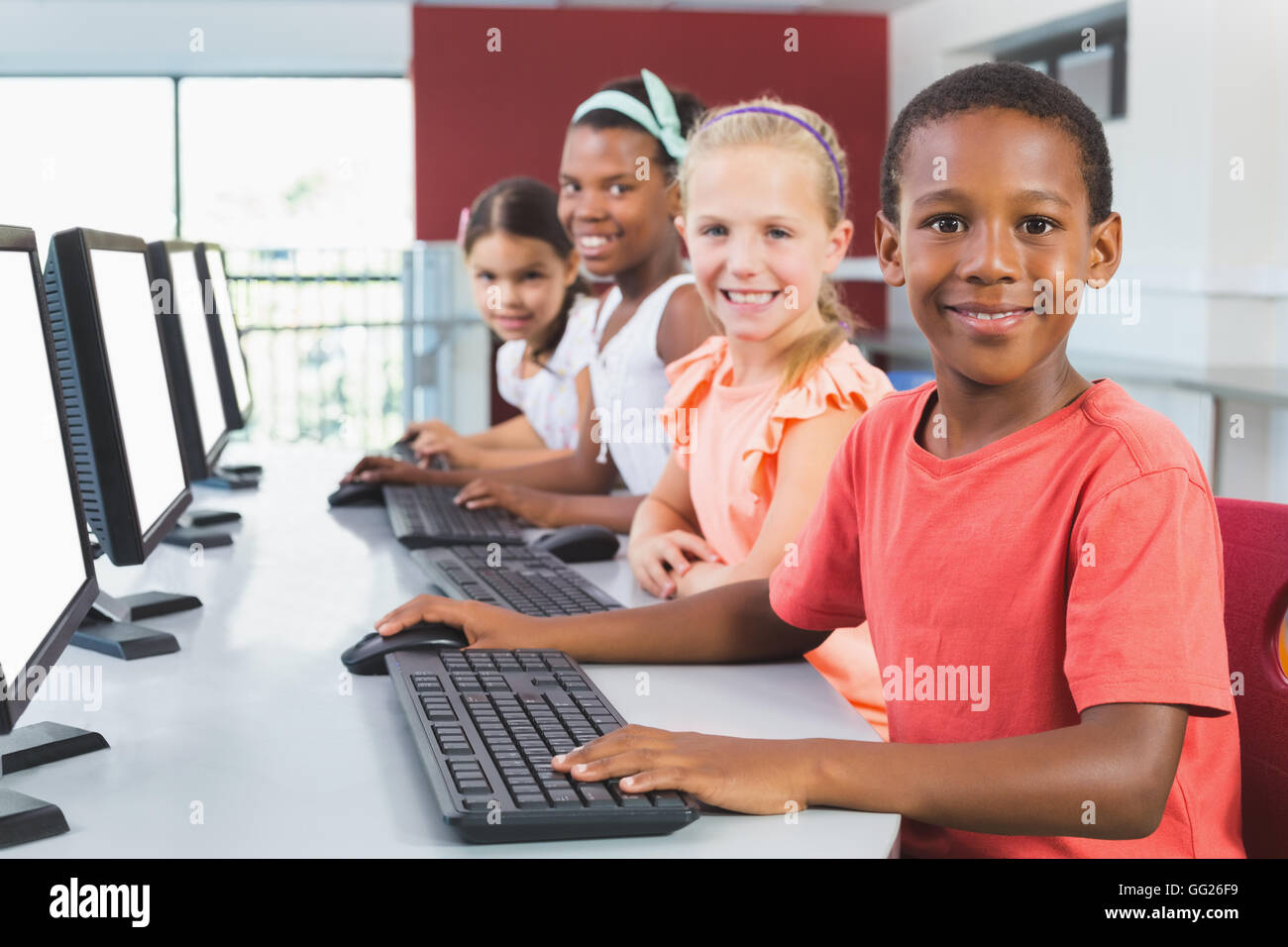 School kids using computer in classroom Stock Photo Alamy