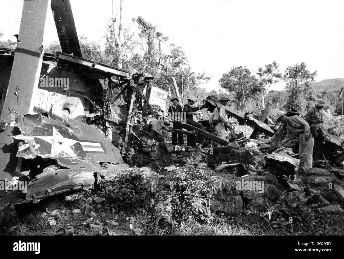 South Vietnam soldiers around a destroyed American tank. 1960s Vietnam war Vietnam information Center Stock Photo