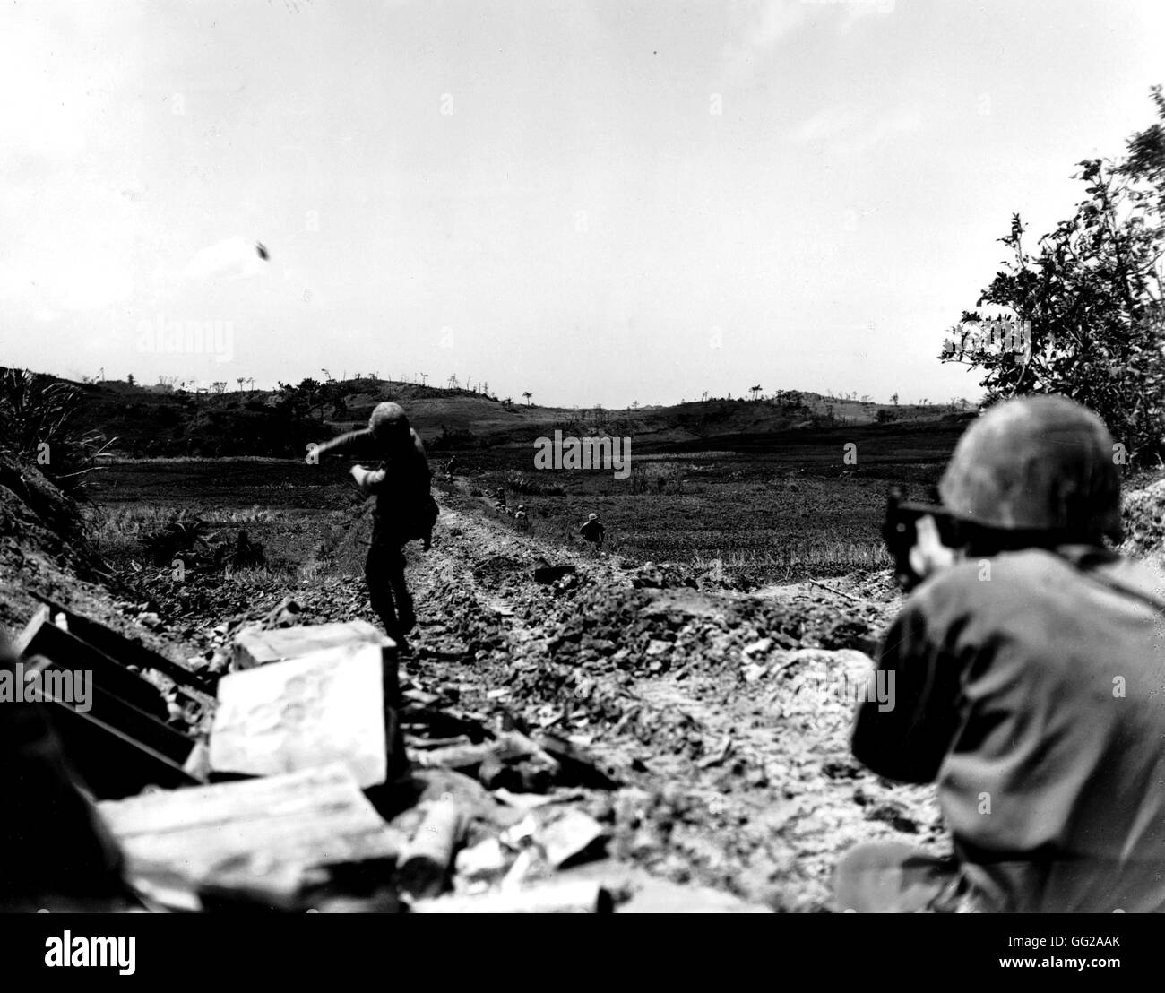The Pacific War in Okinawa: American Marine throwing a grenade towards the Japanese lines May 6, 1945 Japan - World War II U.S. marines corps photograph Stock Photo