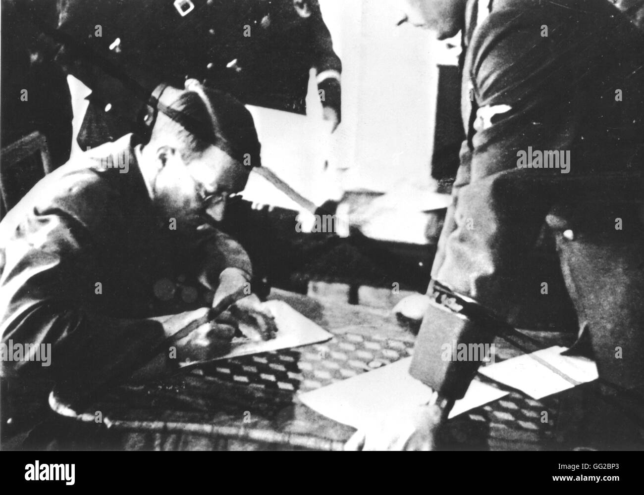 Hitler signing a document about the Protectorate of Bohemia and Moravia at the Prague Haschin. He banned the publishing of this picture because there, he was wearing glasses March 15, 1939 Czechoslovakia Stock Photo