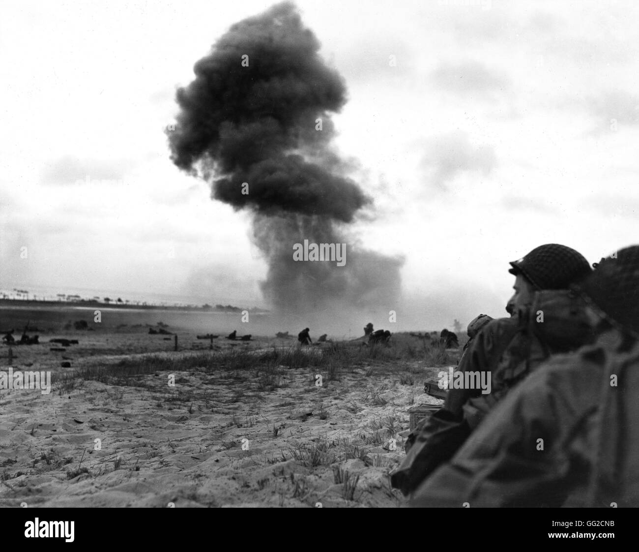 Normandy landings: Enemy bombing on the beach while American troops progress June 1944 France, Second World War war National archives, Washington Stock Photo