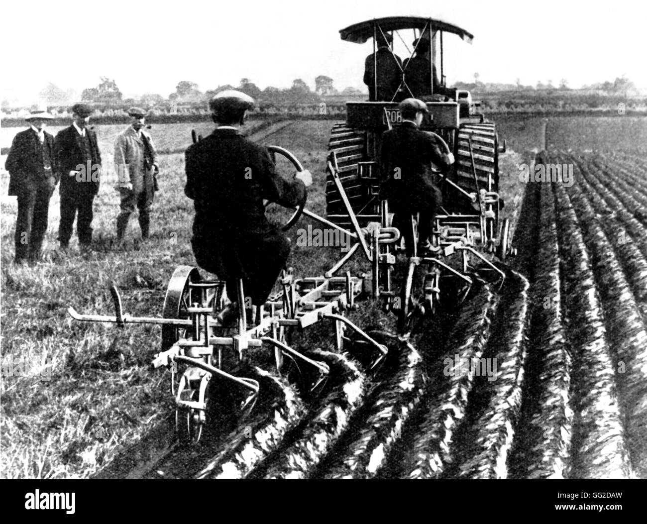 Machines revolutionating the agriculture: Two moldboard plows towed by a steam tractor Early 20th century France Stock Photo