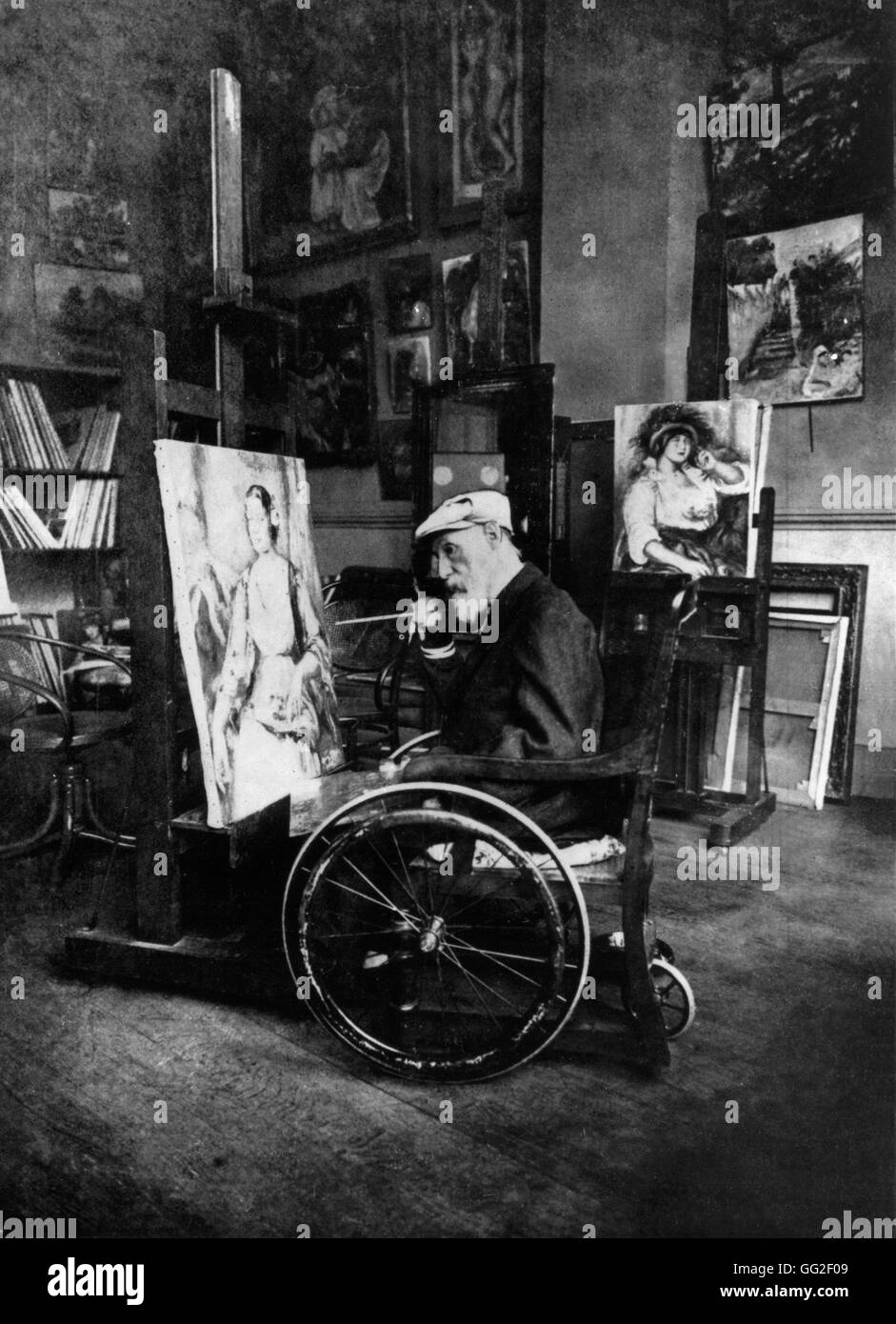 Renoir painting in his wheelchair. On the easel, portrait of Mrs. Tilla Durieux. In the background, portrait of Mrs. Colonna 1914 France Stock Photo