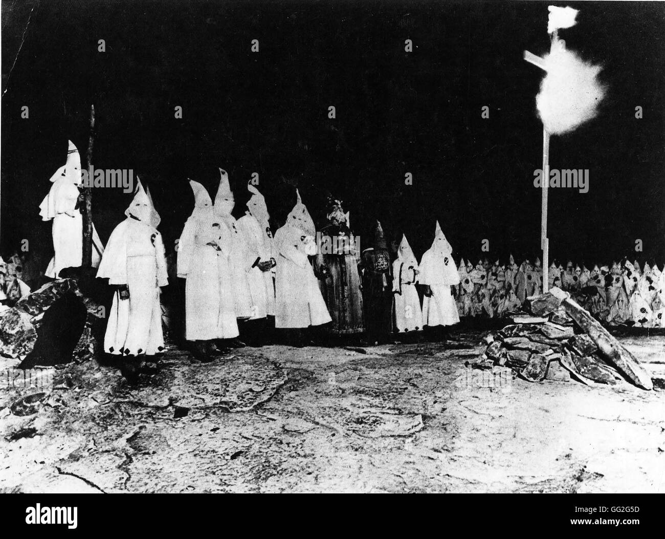 Demonstration of Ku Klux Klansmen burning a cross, Baltimore, Maryland. In the center, in dark costumes, the Exalted Cyclop and the Imperial Wizard. 1923 Stock Photo