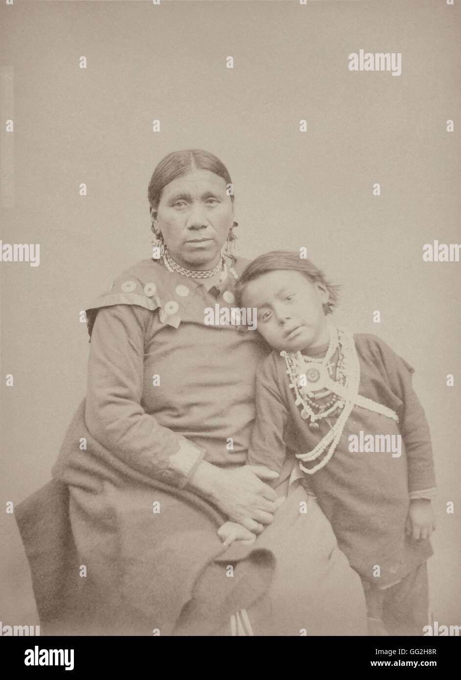 Beautiful Hill (Va-shesh-na-bé), from the Omaha Tribe. She's 35 and is the daughter of a famous Chief called Big-Eye (Inshta-Tanga). She's married to Village-Maker. On the photograph, her son of 5 is posing: he has no name (according to the Indian traditi Stock Photo