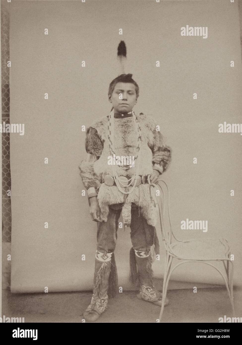 Traveller (Iga-She), from the Omaha Tribe. He's 35 and is the son of Village-Maker and Beautiful Hill. Photograph in: 'Collection anthropologique du prince Roland Bonaparte : Peaux-rouges' ('Anthropological collection of Roland Bonaparte, Prince of Canino Stock Photo