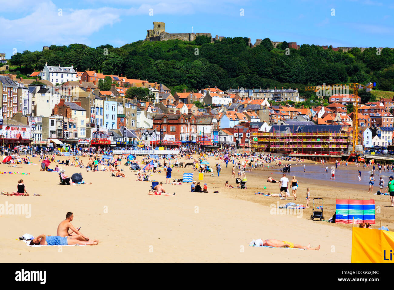 Busy summers day on the beach at Scarborough, North Yorkshire, England. Stock Photo