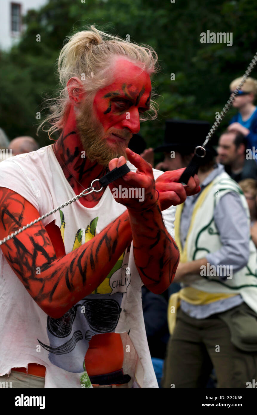Painted male fire dancer in the Beltane Fire Society taking part in the Carnival Parade, part of the Edinburgh Jazz Festival. Stock Photo