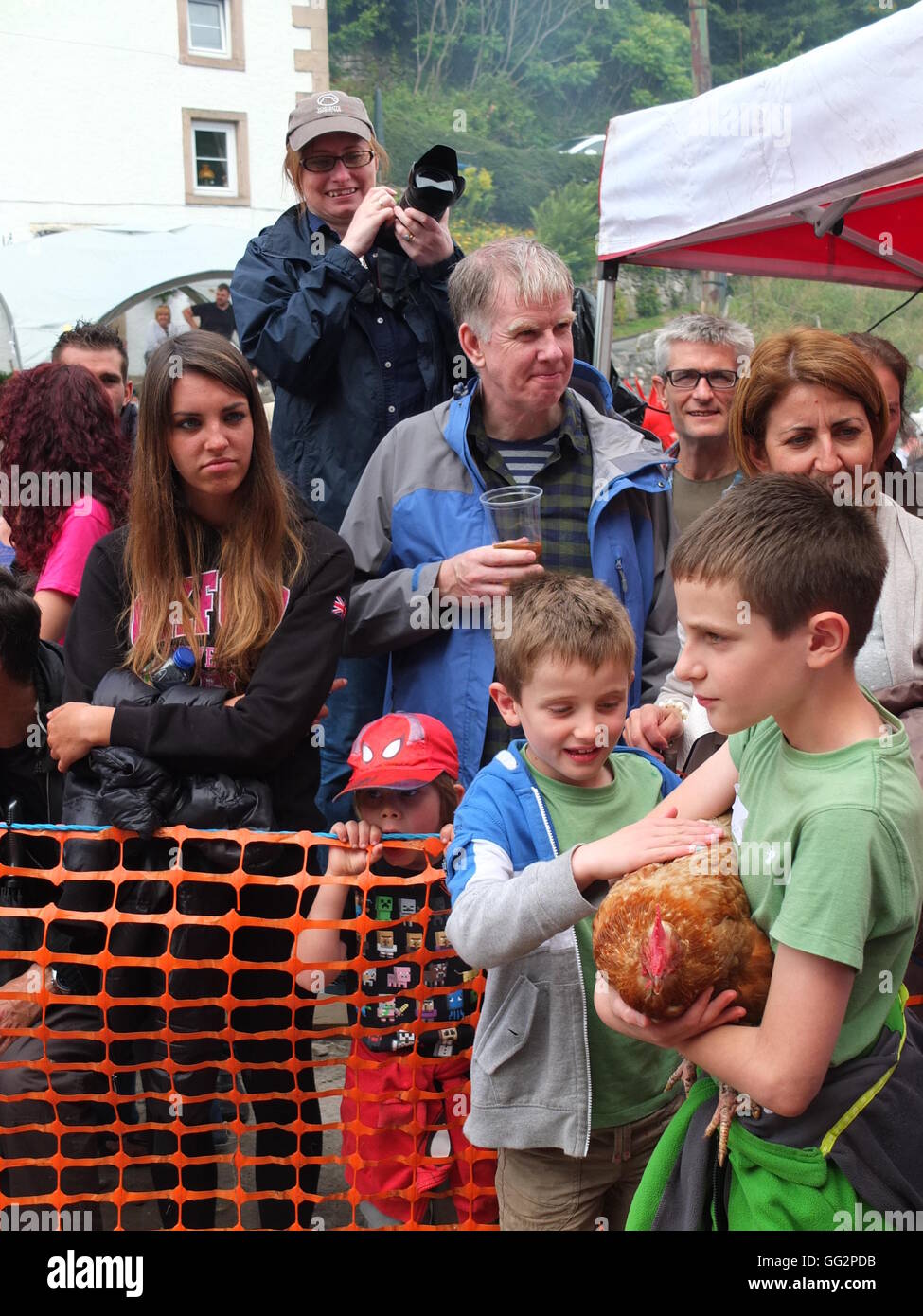 Bonsall World Championship Hen Racing. Young boy waiting to enter his chicken into the contest. Stock Photo