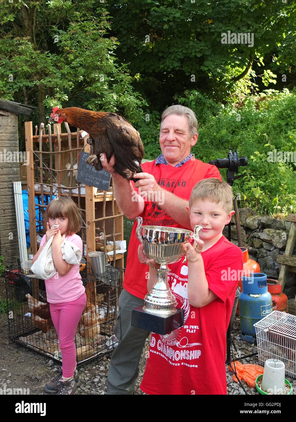 Cooked It, winner of Bonsall World Championship Hen Racing 2015 with owner Jack Allsop-Smith, 7, of Ible and his grandad Stock Photo
