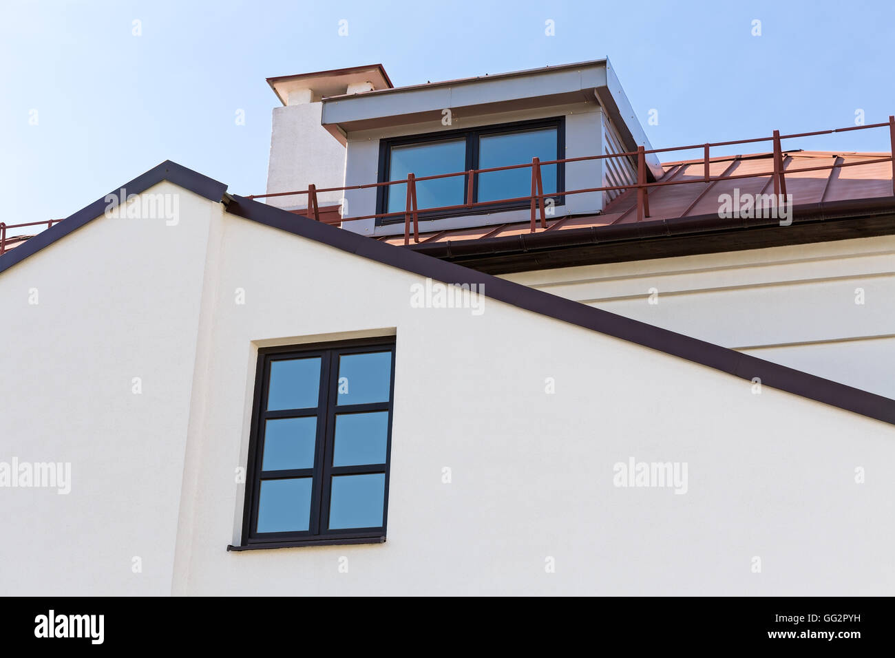 Gable of residential house with dormer window and chimney Stock Photo
