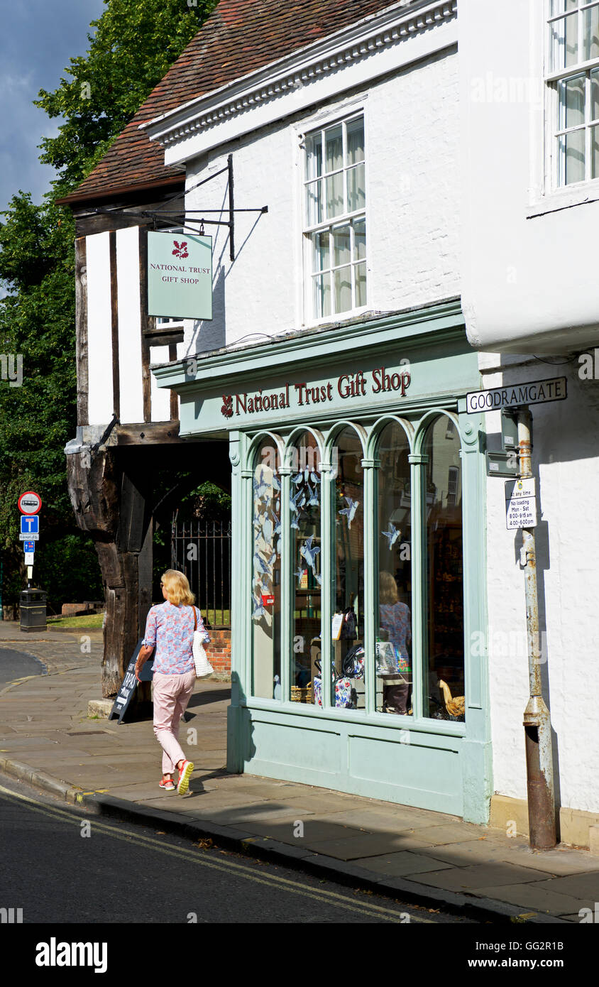 Woman walking past National Trust gift shop, York, North Yorkshire