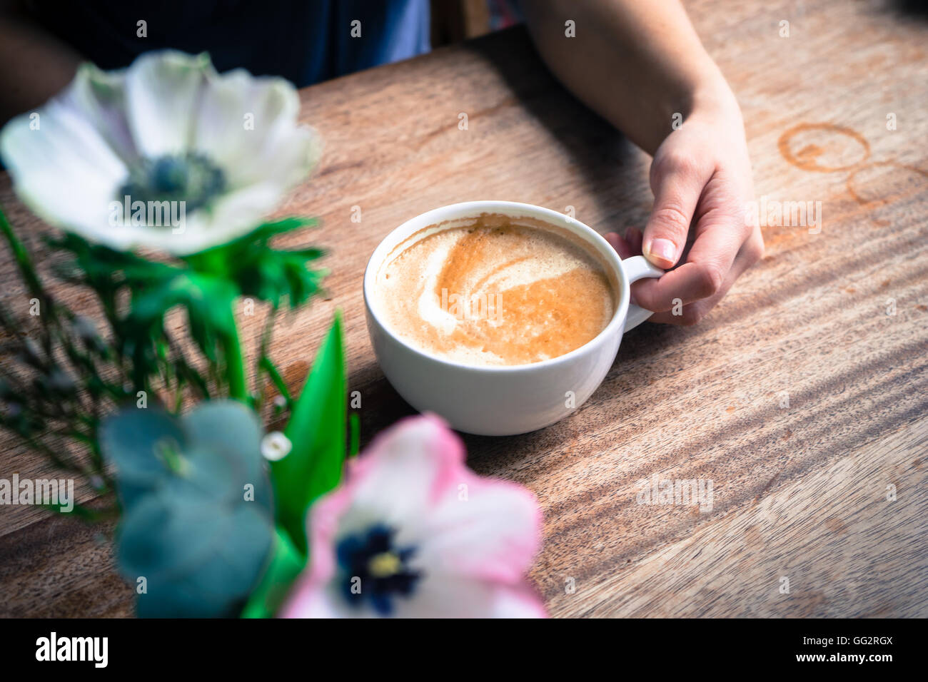 Woman drinking a latte Stock Photo