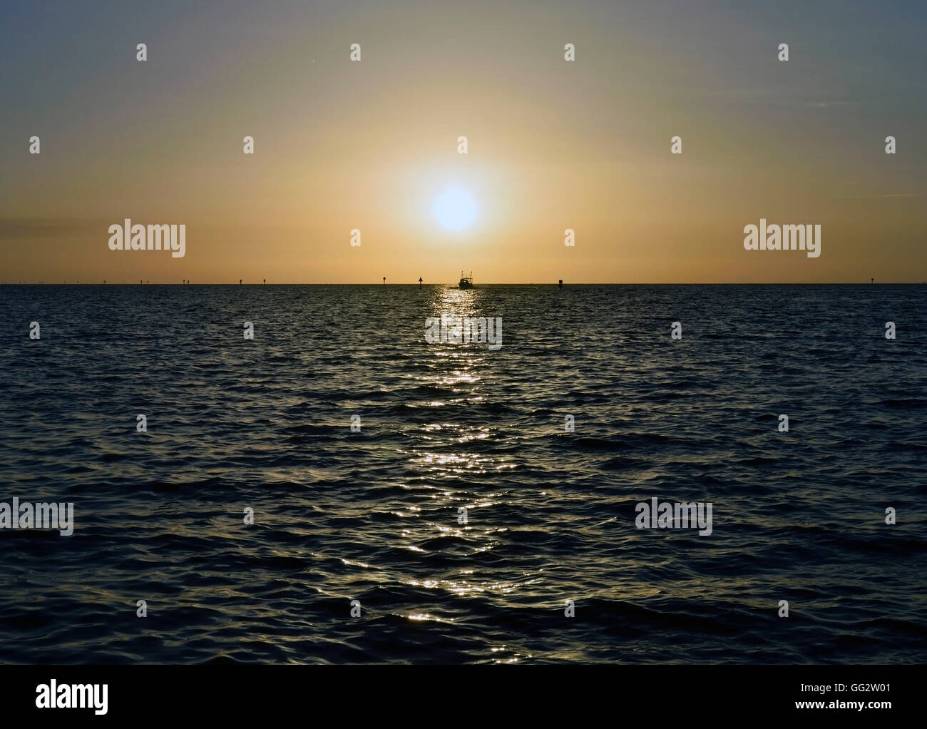 A boat coming in at sunset at Hudson beach, Hudson, Florida Stock Photo