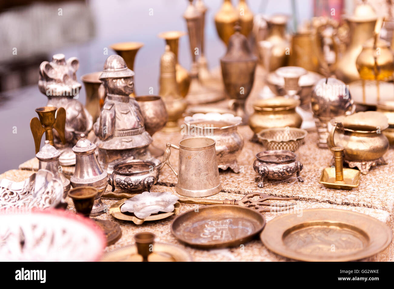 A market stall full of various brass and pewter products for sale. Stock Photo