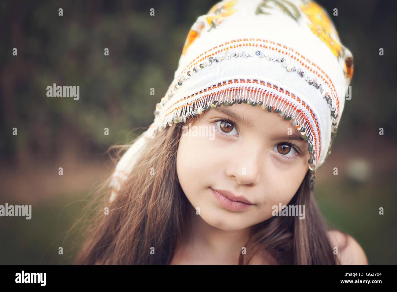 Little girl looking at the camera with turkish handmade scarf on her head Stock Photo