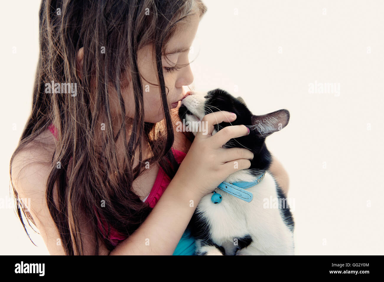 Little girl kissing her cat Stock Photo