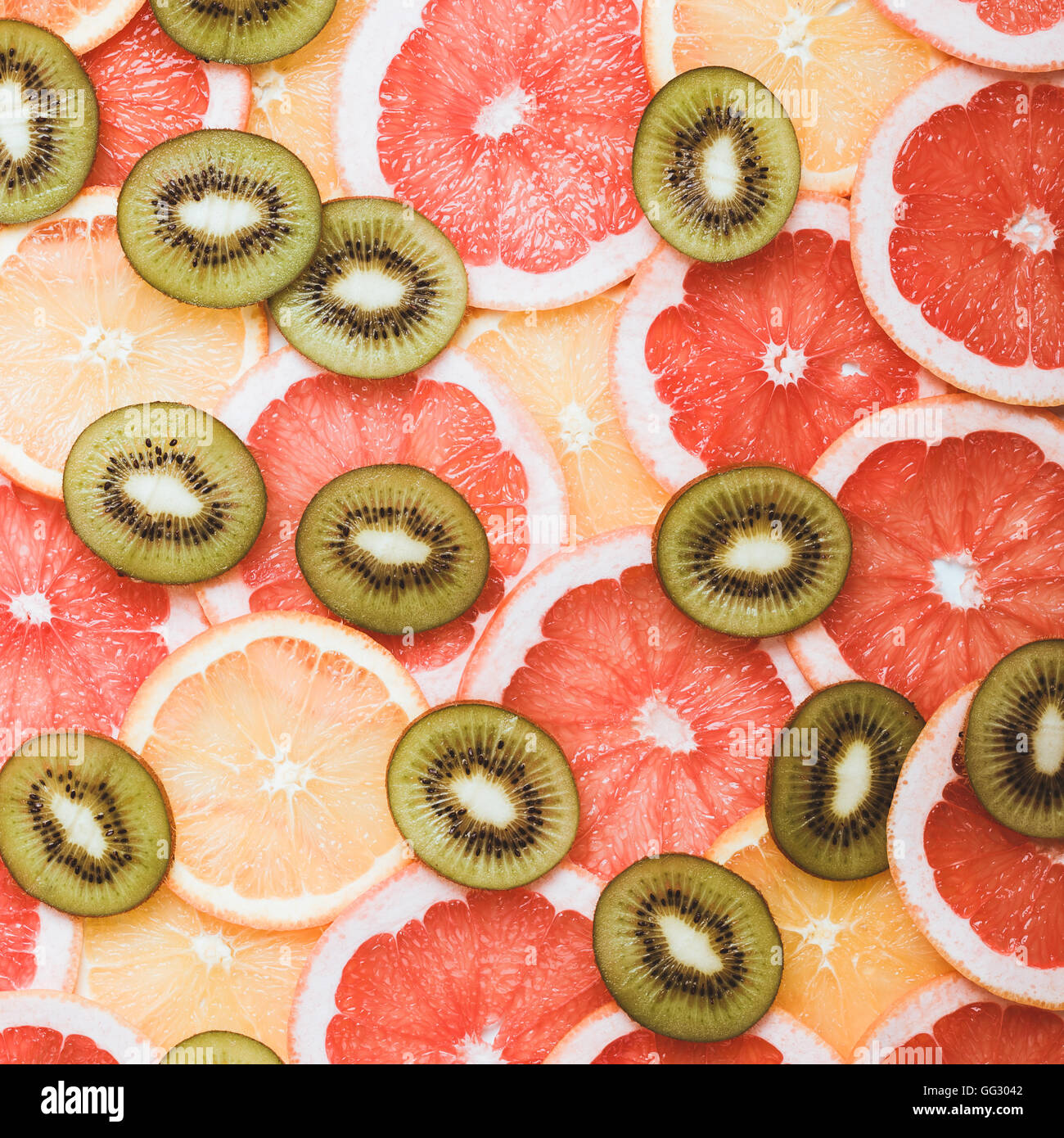 Fresh citrus fruits slices background viewed from above. Grapefruit, orange, kiwi pattern Stock Photo
