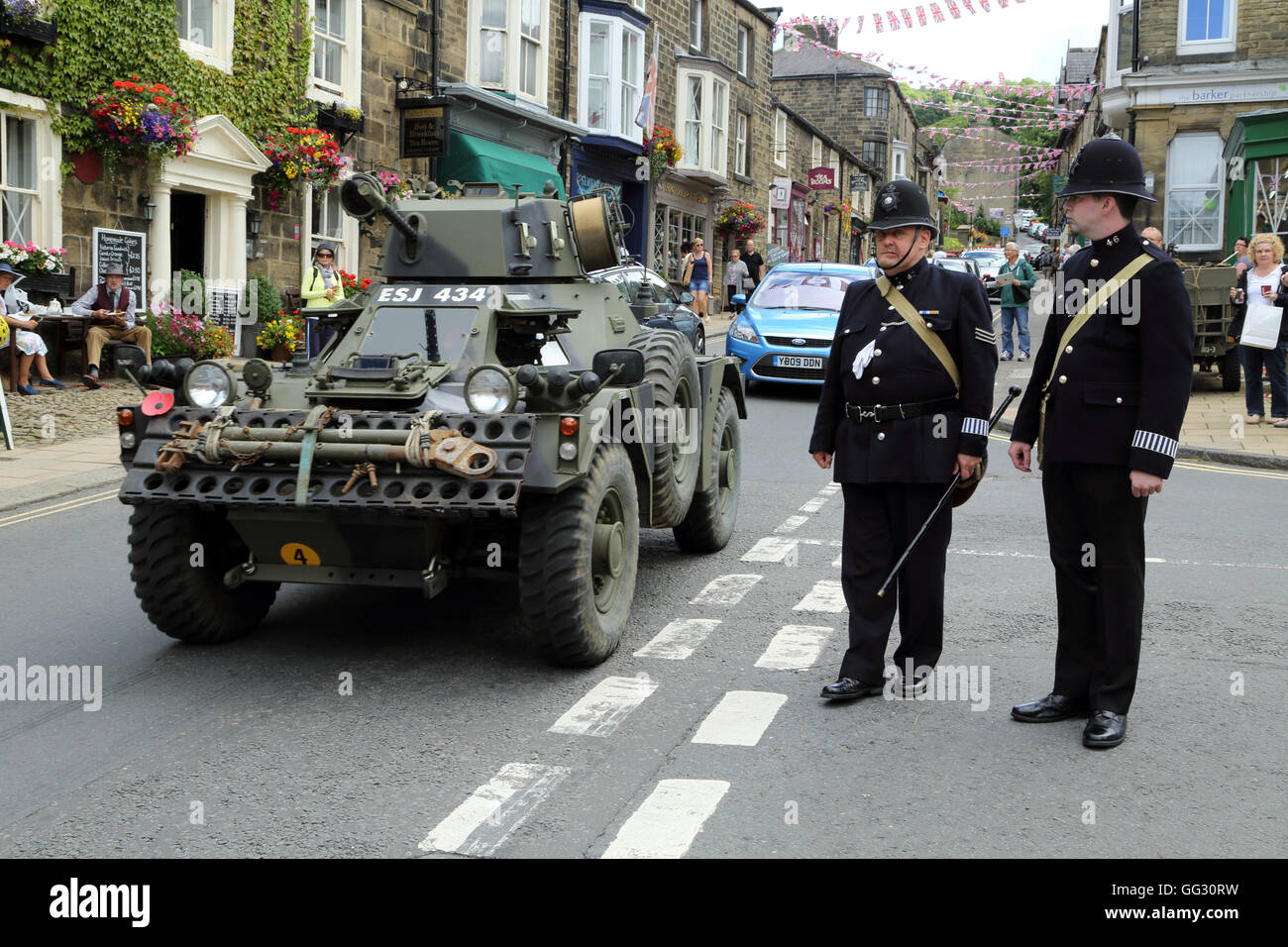 Armoured car and policemen as part of the 1940s weekend in High Street, Pateley Bridge, North Yorkshire, England, United Kingdom Stock Photo