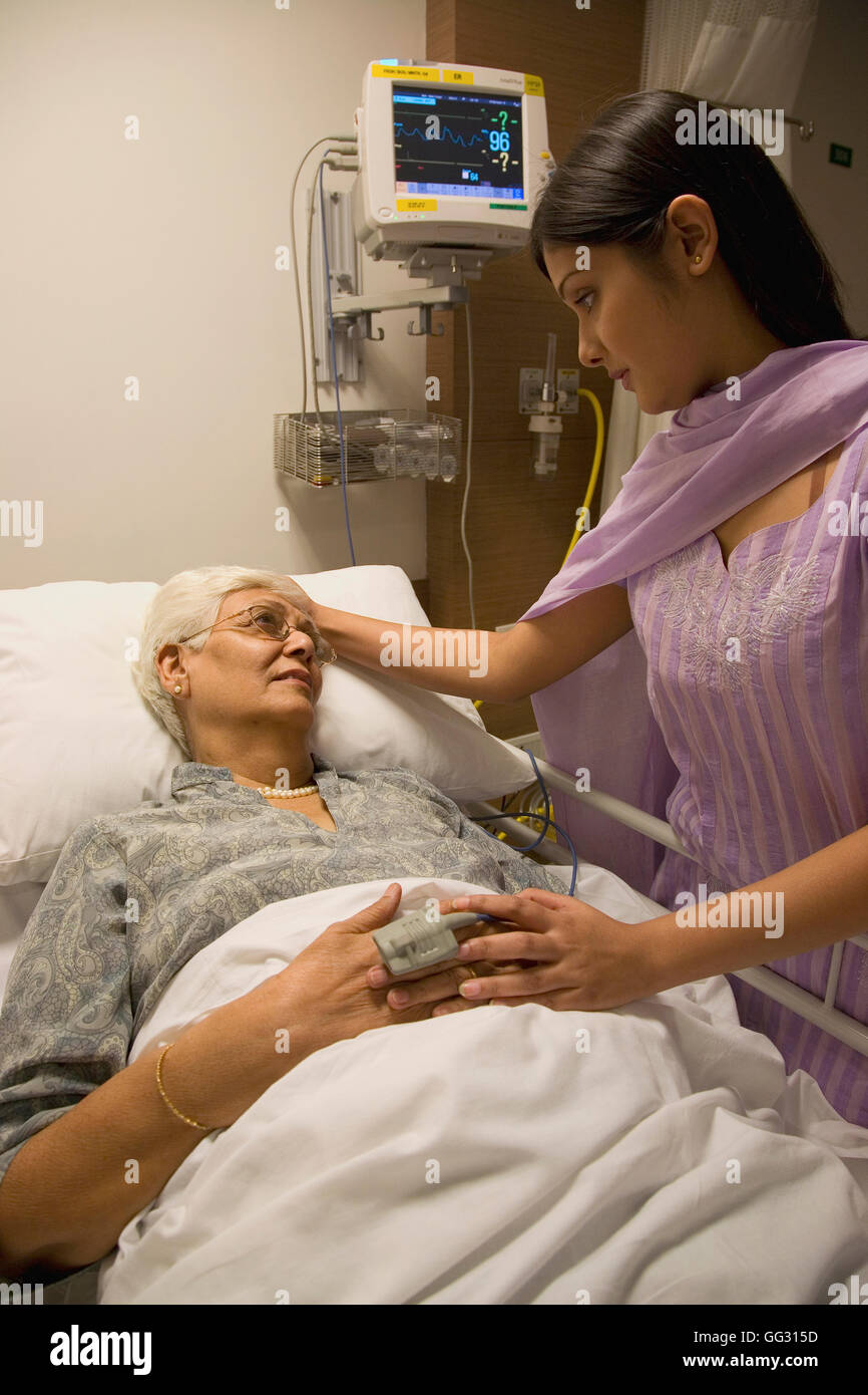 A relative visiting a patient Stock Photo - Alamy