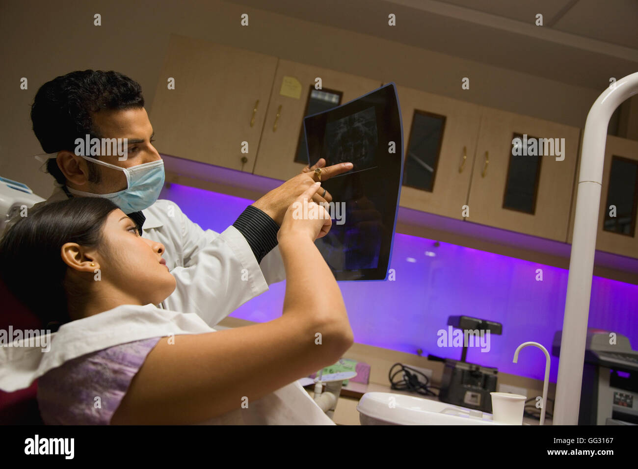 Doctor and patient looking at X-ray Stock Photo
