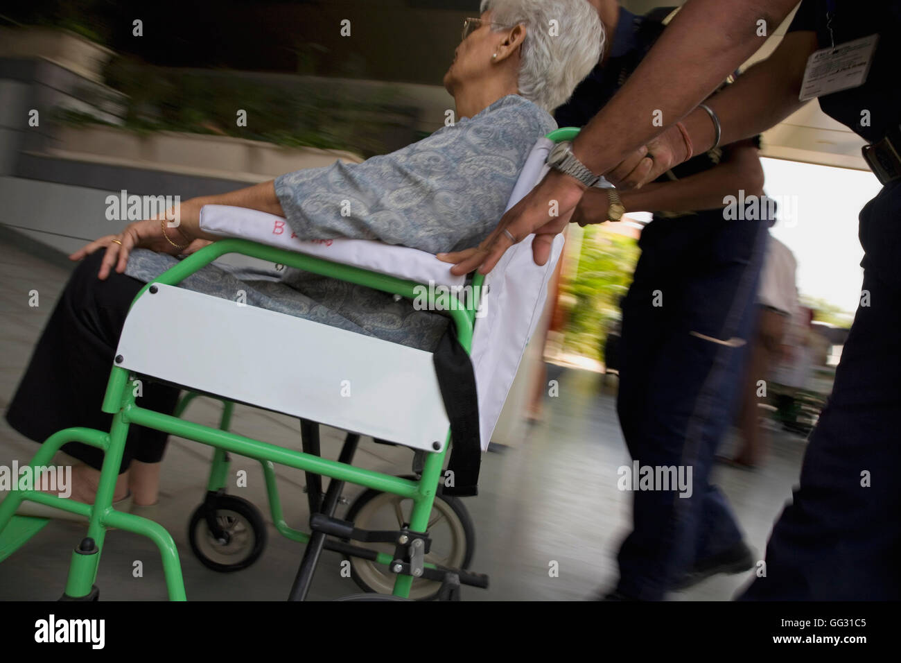 Attendant helping patient on wheelchair Stock Photo Alamy