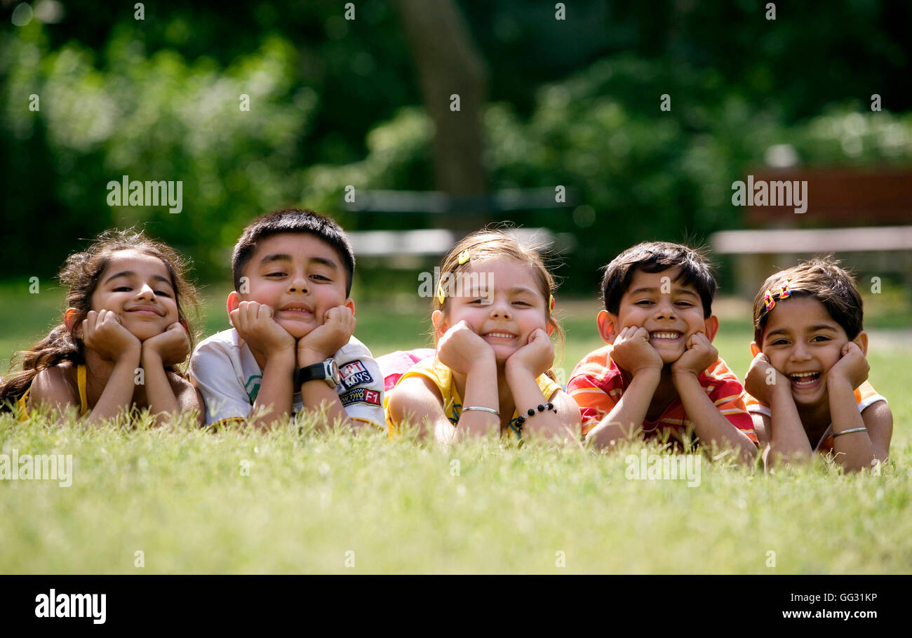 Boy lying on grass chin hi-res stock photography and images - Alamy